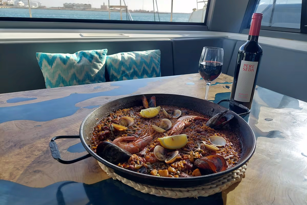 Enjoying traditional paella on a boat tour in Palma Bay Paella served on a solar-powered boat in Palma Bay