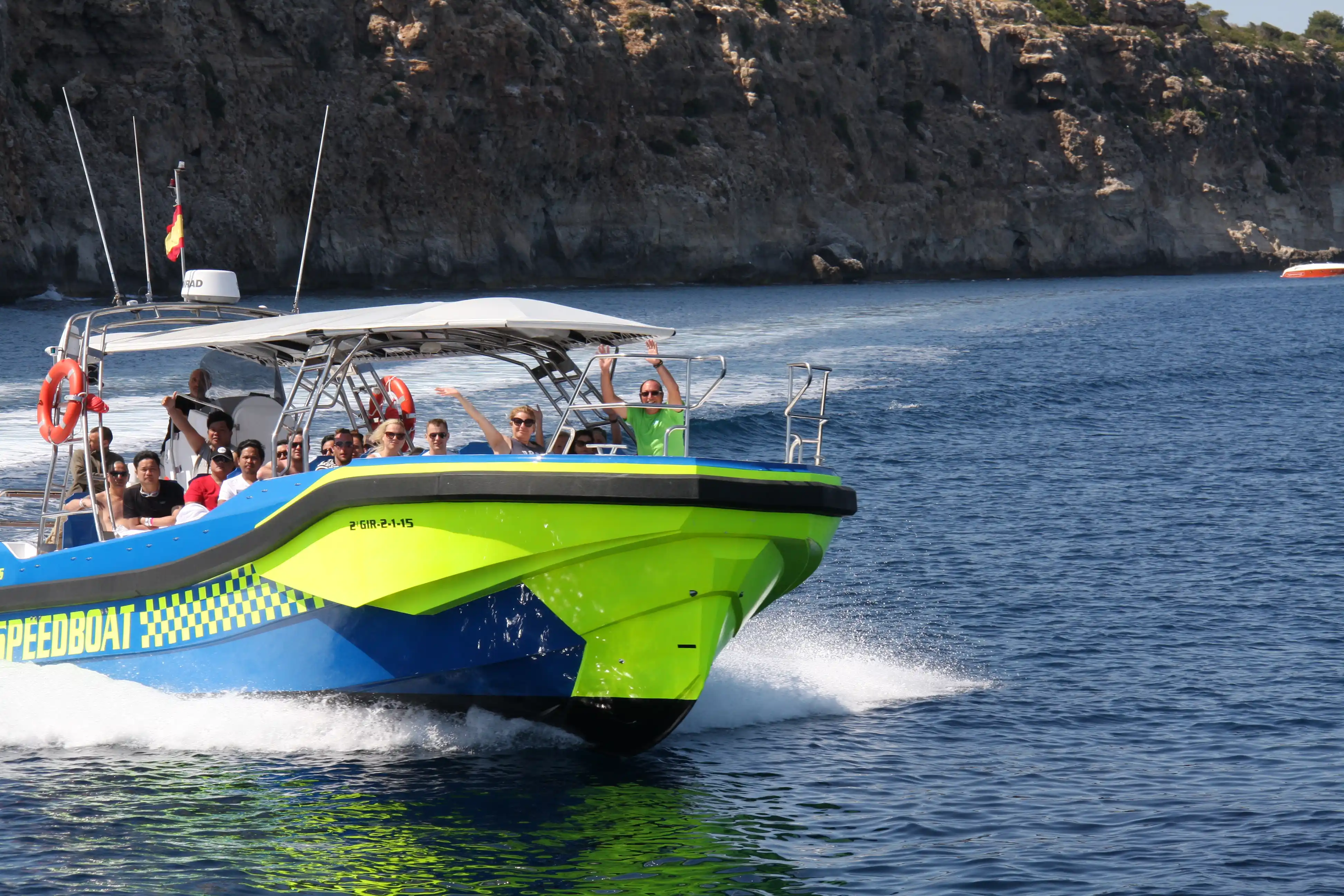 People on a fast speedboat near cliffs in Mallorca.