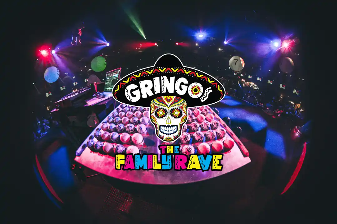 A vibrant logo with a skull and sombrero at a colorful rave party under flashing club lights.