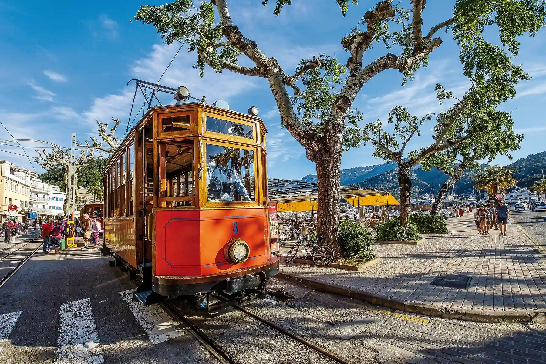 Vintage wooden tram Soller Mallorca sunny day The iconic vintage wooden tram of Soller moving along the tracks on a sunny day in Port de Soller, Mallorca.