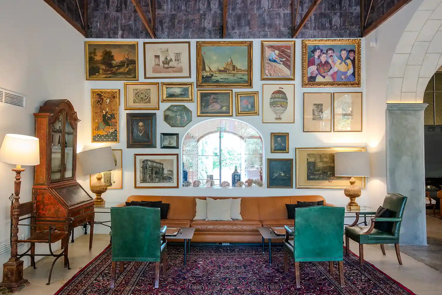 Elegant and cozy hall at the winery with a large sofa and a wall covered with photographs